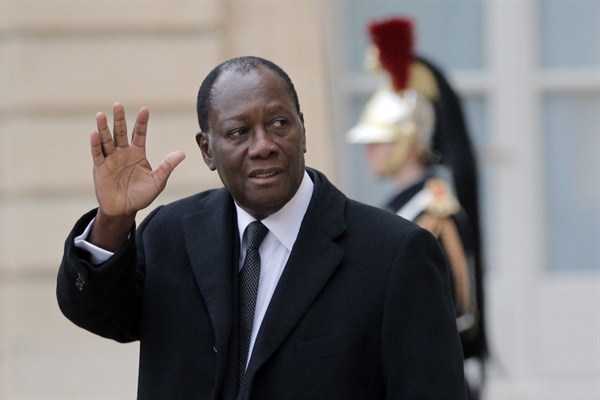 Cote d'Ivoire President Alassane Ouattara waves at reporters after a meeting with French President Francois Hollande at the Elysee Palace, Paris, Dec. 4, 2014 (AP photo by Christophe Ena).