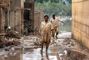 Victims of the worst floods to hit Pakistan in several years walk through water-filled streets, Nowshera, Pakistan, Aug. 3, 2010 (U.N. photo by Amjad Jamal).