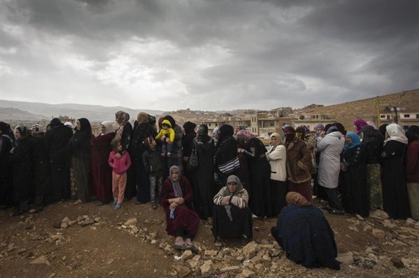 A long line of women refugees from Syria wait to register with UNHCR, Arsal, Lebanon, Nov. 2013 (UNHCR photo).