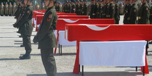 Turkish soldiers stand next to the Turkish flag-draped coffins of eight Turkish soldiers, killed in a roadside bomb, during a ceremony in Siirt, southeastern Turkey, Aug. 20, 2015 (AP photo/Misbah Yilmaz).