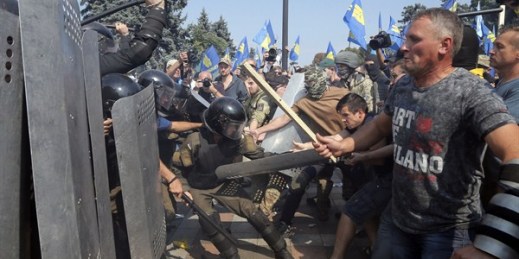 Ukrainian protesters clash with police after a vote to give greater powers to the east, outside the Parliament, Kiev, Ukraine, Aug. 31, 2015 (AP photo by Efrem Lukatsky).