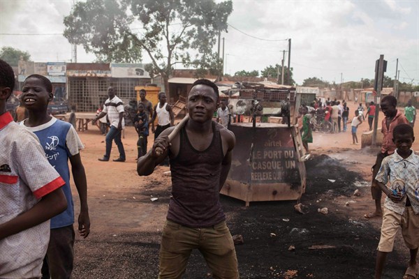 People protesting against the military's coup attempt among the burnt out remains of tires, Ouagadougou, Burkina Faso, Sept. 17, 2015 (AP photo by Theo Renaut).