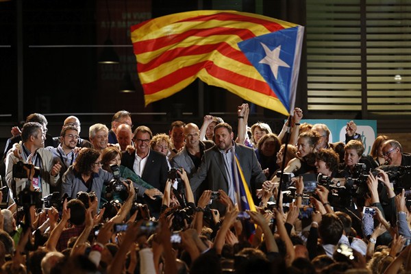 A pro-independence flag is waved at a rally with Catalan President Artur Mas, Barcelona, Spain, Sept. 27, 2015 (AP photo by Manu Fernandez).