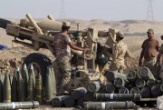 Iraqi security forces and allied Popular Mobilization Forces prepare to shell Islamic State group positions at an oil field outside Beiji, Iraq, Oct. 24, 2015 (AP photo).