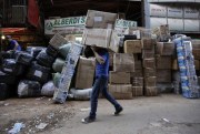 A worker carries packages of goods to send outside the country, Ciudad del Este, Paraguay, May 13, 2015 (AP photo by Jorge Saenz).
