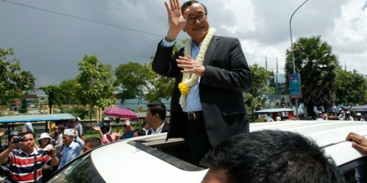 Sam Rainsy, leader of the opposition Cambodia National Rescue Party, greeting supporters, Phnom Penh, Cambodia, Aug. 16, 2015 (AP photo by Heng Sinith).