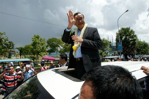 Sam Rainsy, leader of the opposition Cambodia National Rescue Party, greeting supporters, Phnom Penh, Cambodia, Aug. 16, 2015 (AP photo by Heng Sinith).