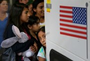 Immigrants from El Salvador and Guatemala who entered the U.S. illegally board a bus after being released from a family detention center in Texas, July 7, 2015 (AP photo by Eric Gay).