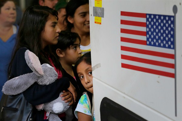 Immigrants from El Salvador and Guatemala who entered the U.S. illegally board a bus after being released from a family detention center in Texas, July 7, 2015 (AP photo by Eric Gay).