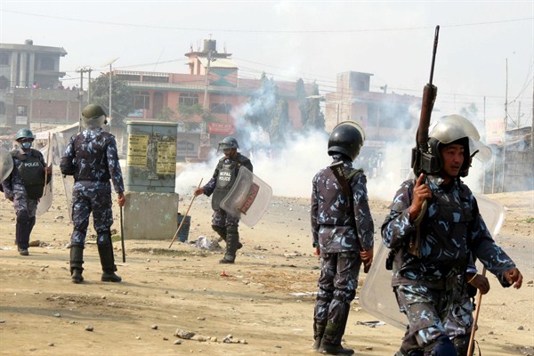 Nepalese policemen disperse ethnic Madhesi protesters in Gaur, on the Indian border, Nepal, Dec. 20, 2015 (AP photo by Gautham Shreshta).