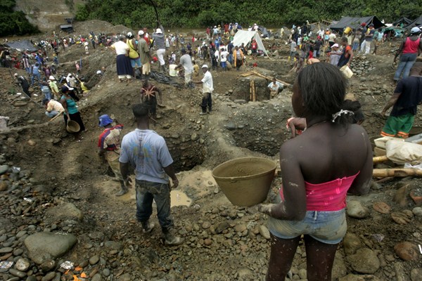 People pan for gold along the Dagua River, Zaragoza, Colombia, July 8, 2009 (AP photo by Christian Escobar Mora).