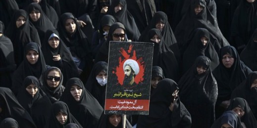 An Iranian woman holds up a poster of Sheikh Nimr al-Nimr at a protest, Tehran, Iran, Jan. 4, 2016 (AP photo by Vahid Salemi).