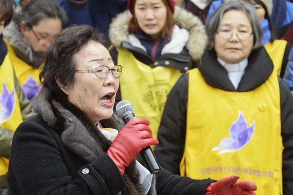 A woman who was forced to provide sex for Japanese soldiers during World War II speaks at a rally in front of the Japanese Embassy, Seoul, Dec. 30, 2015 (Kyodo via AP Images).