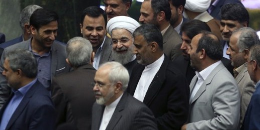 Iranian President Hassan Rouhani surrounded by lawmakers as he arrives at the parliament, Tehran, Iran, Jan. 17, 2016 (AP photo by Vahid Salemi).