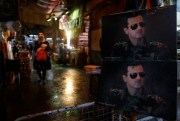 Pictures of Syrian President Bashar Assad at a checkpoint to the Hamidiyeh market, Damascus, Syria, Feb. 21, 2016 (AP photo by Hassan Ammar).