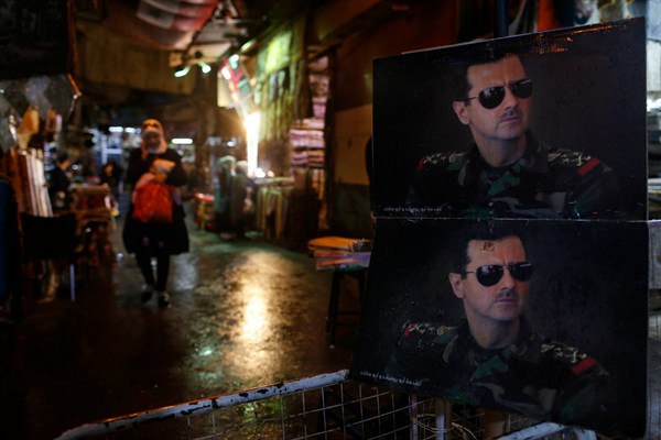 Pictures of Syrian President Bashar Assad at a checkpoint to the Hamidiyeh market, Damascus, Syria, Feb. 21, 2016 (AP photo by Hassan Ammar).