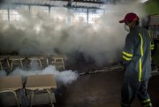 Fumigating a classroom in a mosquito eradication effort against the spread of the Zika virus, Santa Tecla, El Salvador, Jan. 28, 2016 (AP photo by Salvador Melendez).