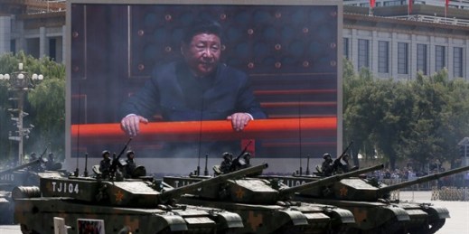 Chinese President Xi Jinping is displayed on a big screen as Type 99A2 Chinese battle tanks roll across during a military parade, Sept. 3, 2015 (AP photo by Ng Han Guan).