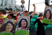 Women carry images of slain environmental activist Berta Caceres, Tegucigalpa, Honduras, March 8, 2016 (AP photo by Fernando Antonio).