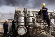 Iraqi workers are seen at the Rumaila oil refinery, near Basra, Iraq, Dec. 13, 2009 (AP photo by Nabil al-Jurani).