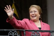 Chilean President Michelle Bachelet waves from a palace balcony, Quito, Ecuador, Oct. 15, 2015 (AP photo by Dolores Ochoa).