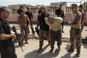 Iraqi security forces arrest a suspected ISIS fighter during an operation to regain control of Hit, Iraq, April 13, 2016 (AP photo by Khalid Mohammed).