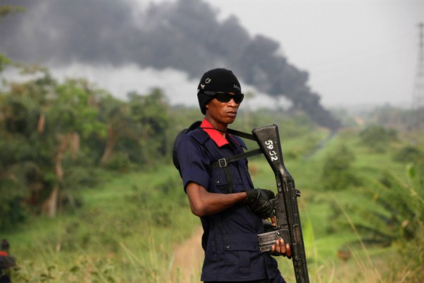 A member of Nigeria's civil defense corps secures an area following an explosion at a gas pipeline, Arepo, Ogun, Nigeria, Jan. 23, 2013 (AP photo by Sunday Alamba).