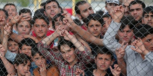 Migrants behind a fence at the Nizip refugee camp, Gaziantep province, southeastern Turkey, April 23, 2016 (AP photo by Lefteris Pitarakis).