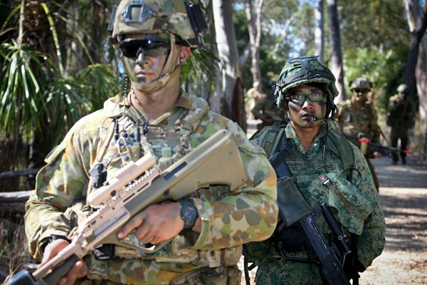 Soldiers from Australia and Singapore head out on patrol during Exercise Trident, Queensland, Australia, Nov. 8, 2014 (Australian Defense Department photo).