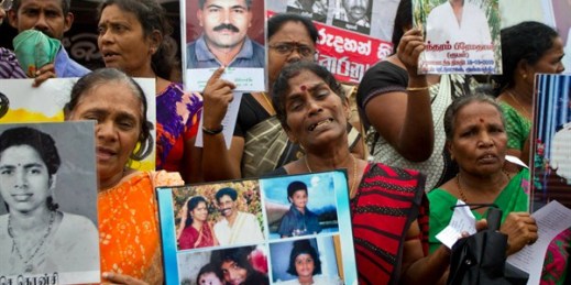 Sri Lankan ethnic Tamil women hold photographs of their missing family members, Colombo, Sri Lanka, Dec. 10, 2015 (AP photo by Eranga Jayawardena).