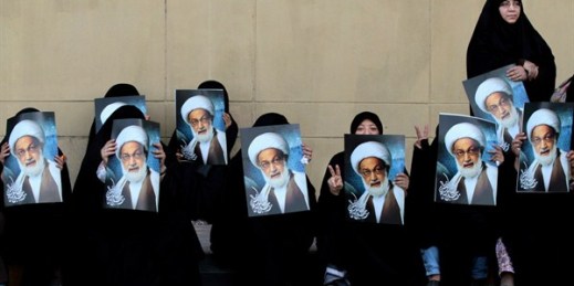 Bahraini anti-government protesters hold posters of top Shiite cleric Sheik Isa Qassim, Karrana, Bahrain, May 17, 2013 (AP photo by Hasan Jamali).