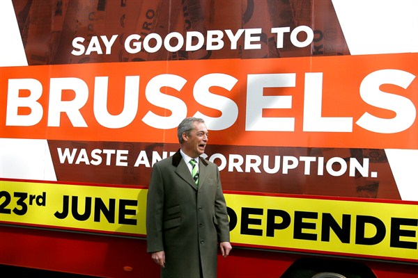 Nigel Farage, leader of Britain's UKIP party, in front of a 'Grassroots Out' banner, London, March 31, 2016 (AP photo by Kirsty Wigglesworth).