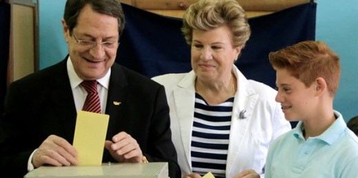 Cypriot President Nicos Anastasiades, with his wife Andri and their grandson Andi, casts his ballot at a polling station during the parliamentary elections, Limassol, Cyprus, May 22, 2016 (AP photo by Petros Karadjias).