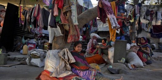 Indian laborers rest under a tree where they live, Ahmadabad, India, Jan. 19, 2016 (AP photo by Ajit Solanki).