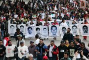 Relatives of the 43 missing students from the Isidro Burgos rural teachers college march holding pictures of their missing loved ones, Mexico City, Dec. 26, 2014 (AP photo by Marco Ugarte).