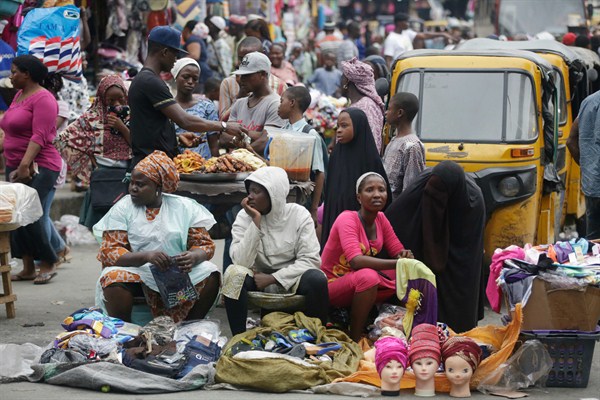 People crowd around market stalls, Lagos, Nigeria, June 20, 2016 (AP photo by Sunday Alamba).
