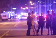 Orlando police officers direct people away from the fatal shooting at Pulse nightclub, Orlando, Fla., June 12, 2016 (AP photo by Phelan M. Ebenhack).