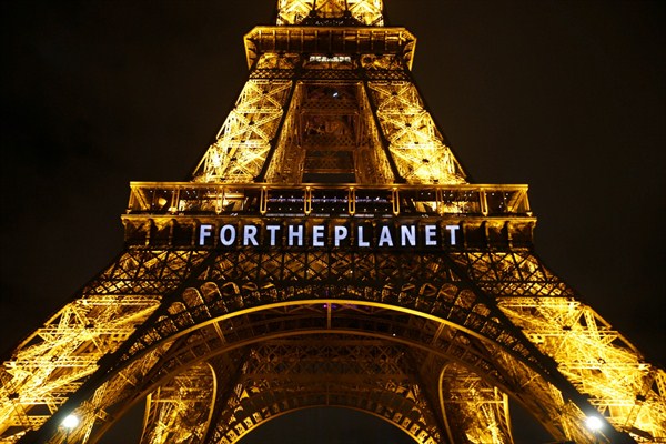The Eiffel Tower lit up with a slogan as part of the United Nations Climate Change Conference in Paris, Dec. 11, 2015 (AP photo by Francois Mori).