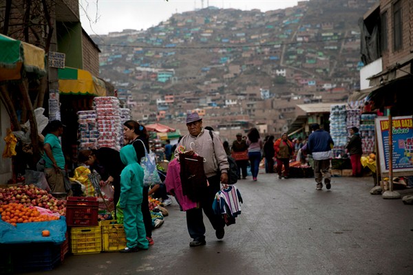 Street vendors begin their workday, Villa Maria del Triunfo, Peru, Oct. 6, 2015 (AP photo by Rodrigo Abd).