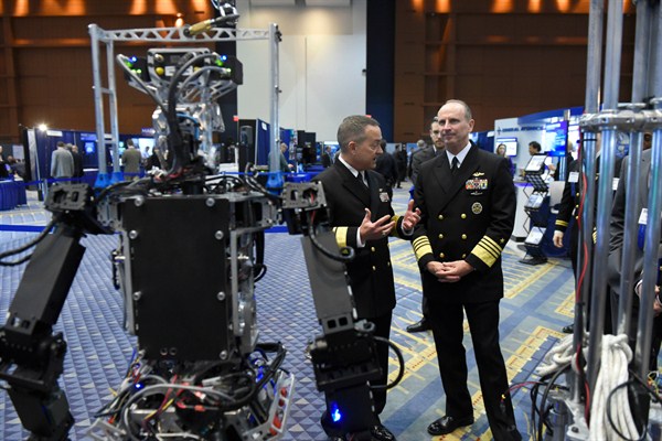 Navy Rear Adm. Mat Winter, left, and Navy Adm. Jonathan Greenert with the Navy-sponsored Shipboard Autonomous Firefighting Robot, Washington, Feb. 4, 2015 (Department of Defense photo).