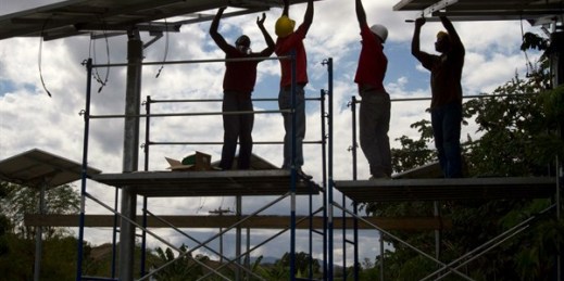 People install solar panels as part of relief efforts from the January 2010 earthquake, Boucan Carre, Haiti, Feb. 14, 2012, (AP photo by Dieu Nalio Chery).