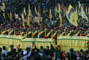 Relatives and comrades pray as they surround the Hezbollah flag-draped coffins of Shiite fighters who were killed in Syria, Nabatiyeh, Lebanon, Oct. 27, 2015 (AP photo by Mohammed Zaatari).