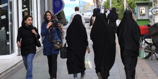 Iranian women walk along a sidewalk, Tehran, Iran, April 26, 2016 (AP photo by Vahid Salemi).