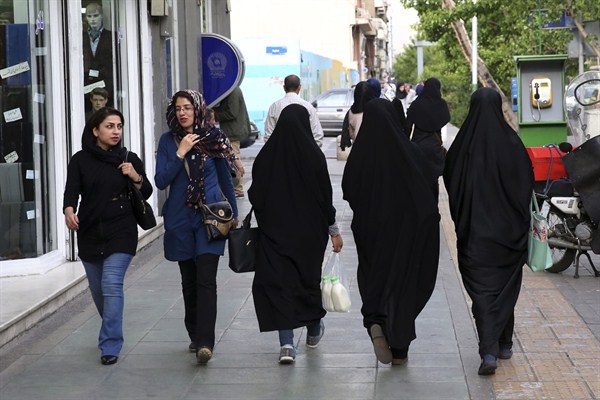 Iranian women walk along a sidewalk, Tehran, Iran, April 26, 2016 (AP photo by Vahid Salemi).