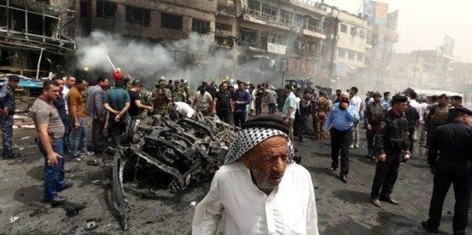 Iraqi security forces and civilians gather at the scene of a deadly suicide car bomb attack, Baghdad, Iraq, June 9, 2016 (AP photo by Hadi Mizban).