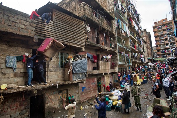 Residents lower furniture down to the street as they and others are evicted from their apartment blocks near the site of the building collapse, Nairobi, Kenya, May 6, 2016 (AP photo by Ben Curtis).