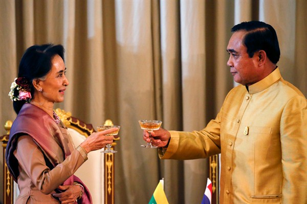 Myanmar's foreign minister and state counselor, Aung San Suu Kyi, with Thai Prime Minister Prayuth Chan-ocha during a ceremony, Bangkok, Thailand, June 24, 2016 (AP photo by Jorge Silva).