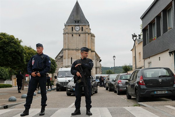 Police officers prevent access to the church where a hostage-taking claimed by ISIS left a priest dead, Normandy, France, July 27, 2016 (AP photo by Francois Mori).