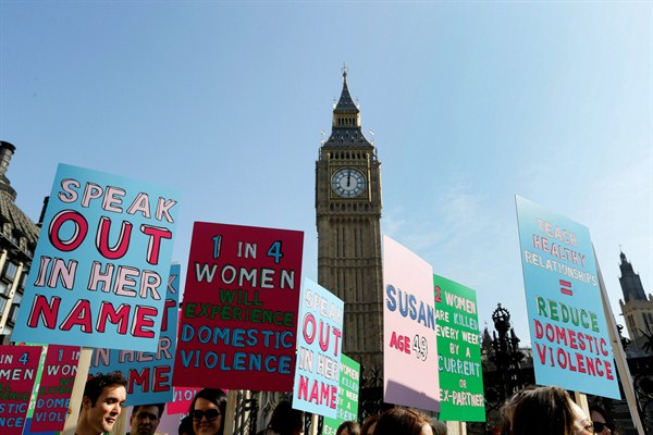 Protesters hold banners during a demonstration against domestic violence, London, U.K., March 5, 2013 (AP photo by Kirsty Wigglesworth).
