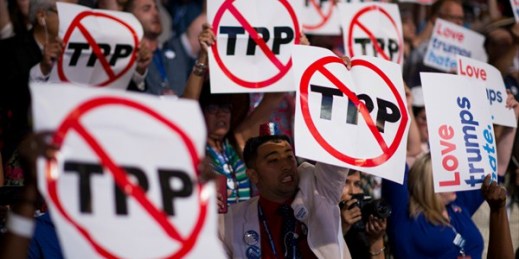 Delegates supporting Bernie Sanders wave anti-TPP signs at the Democratic National Convention, Philadelphia, July 25, 2016 (CQ Roll Call photo by Bill Clark via AP).